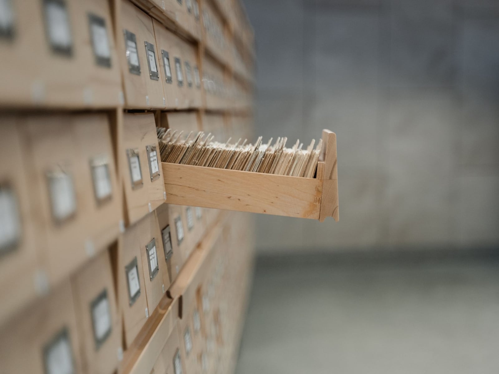 A custom-made archival book box in grey acid-free cloth protecting a precious book.